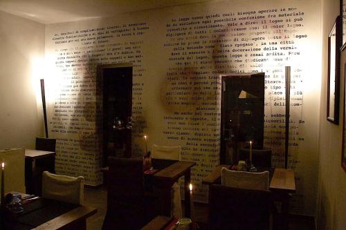 a restaurant with a wall with writing on it at La Bussola Da Gino in Quarrata