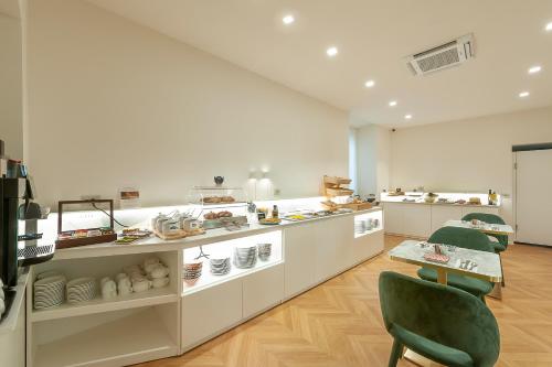 a room with a counter and chairs in a store at Dei Priori Boutique Hotel in Assisi