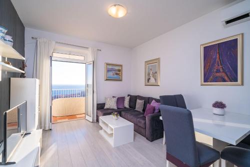 a living room with a couch and a table at Isaura Apartments in Dubrovnik