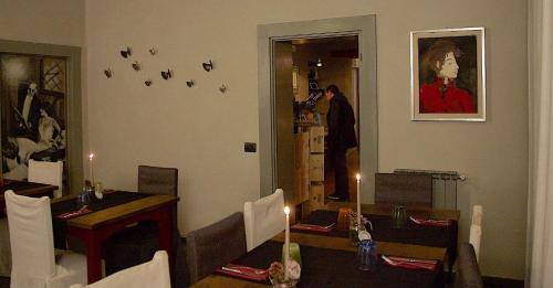 a dining room with a table and a man in the kitchen at La Bussola Da Gino in Quarrata