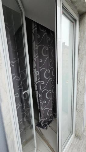 a window in a house with a curtain in it at HOTEL CRISARI in Naples