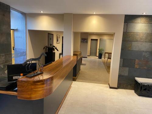 a lobby with a wooden counter in a building at Tierra Mora in San Rafael