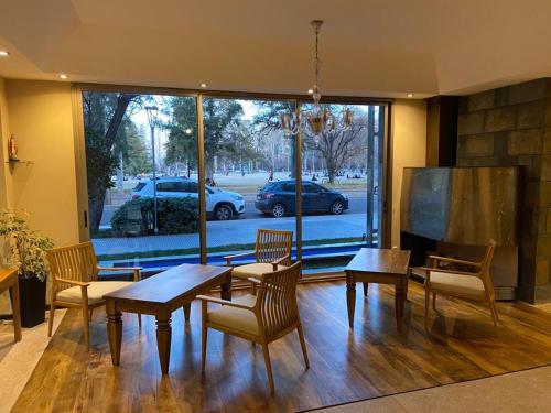 a dining room with tables and chairs and a large window at Tierra Mora in San Rafael