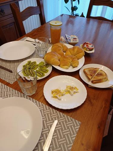 a wooden table with plates of food on it at B&B Casa Tua in Venafro