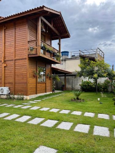 Casa con balcón y patio de césped en Millicent Residence - Chalet Milly e Chalet Iris - Itaoca Praia - ES, en Itapemirim