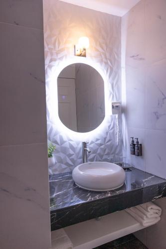 a bathroom with a sink and a mirror on a counter at Hotel Balcón del Cielo in Guanajuato