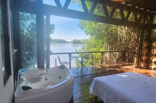 a bath tub on a deck with a view of the water at Willo's Treehouse in Escuintla
