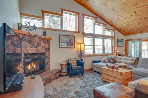 a living room with a fireplace in a house at Lakefront Tomahawk Getaway with Deck and 2 Fireplaces! in Tomahawk