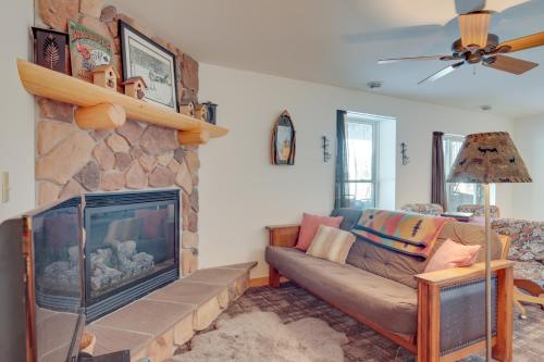 a living room with a couch and a fireplace at Lakefront Tomahawk Getaway with Deck and 2 Fireplaces! in Tomahawk