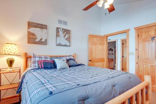 a bedroom with a bed and a ceiling fan at Lakefront Tomahawk Getaway with Deck and 2 Fireplaces! in Tomahawk