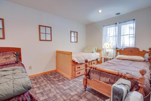 a bedroom with two beds and a dresser at Lakefront Tomahawk Getaway with Deck and 2 Fireplaces! in Tomahawk