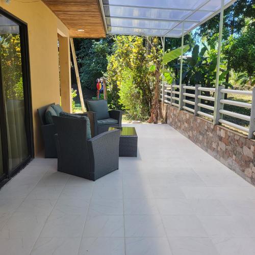 an outdoor patio with chairs and a fence at Villas Playa Palo Seco in Parrita