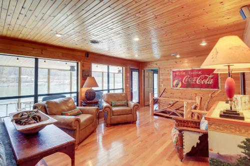 a living room filled with furniture and a wooden ceiling at Spacious Cabin with Private Dock on White River! in Flippin