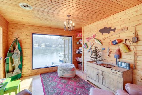 a room with a large window in a wooden wall at Spacious Cabin with Private Dock on White River! in Flippin