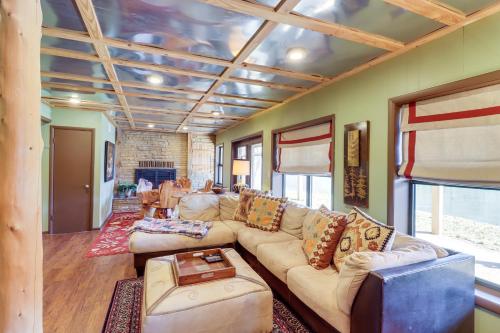 a living room with a couch and a table at Spacious Cabin with Private Dock on White River! in Flippin