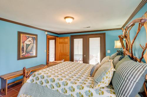 a bedroom with a large bed with blue walls at Spacious Cabin with Private Dock on White River! in Flippin