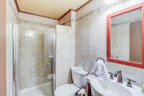 a bathroom with a toilet and a sink and a shower at Spacious Cabin with Private Dock on White River! in Flippin
