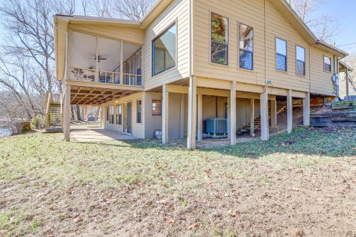 a large house with a porch and a yard at Spacious Cabin with Private Dock on White River! in Flippin