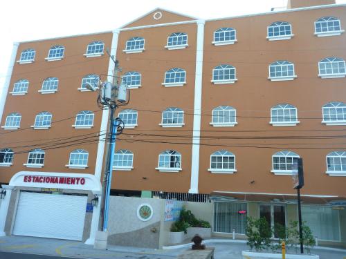 an orange building with white windows on a street at Residencial El Amanecer in Panama City