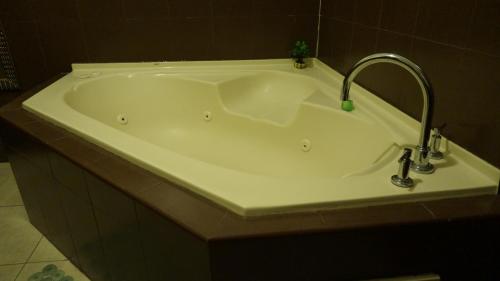 a white bath tub with a faucet in a bathroom at Residencial El Amanecer in Panama City