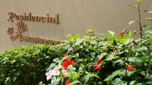 a sign for a hospital with flowers in front of it at Residencial El Amanecer in Panama City