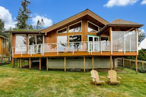 a large house with a deck and two chairs at Luxury Beach Home Ocean View Sonos in Langley