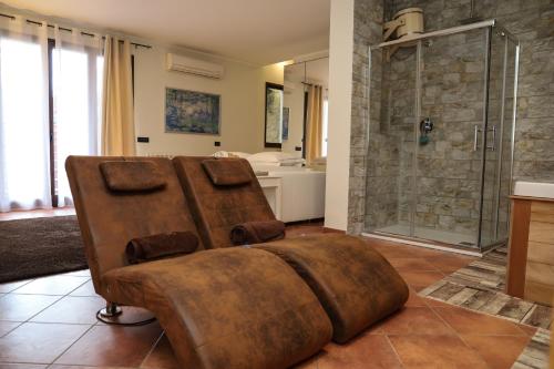 a large bathroom with a shower and a couch at Casita Garden&Spa in Carini