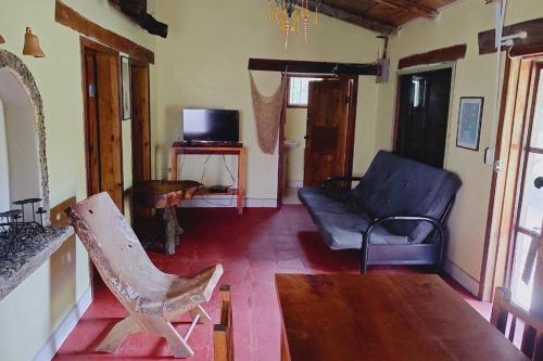 a living room with a couch and a chair at Cabaña La tortuga in Siguatepeque