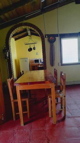 a wooden table and chairs in a room at Cabaña La tortuga in Siguatepeque