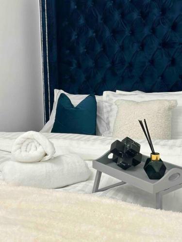 a bedroom with a bed with a blue head board at Luxury SuperKingsize Bed in London in London