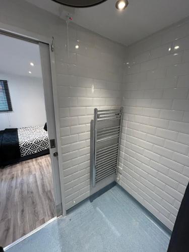 a room with white brick walls and a bedroom at Hertford HOME in Hertford