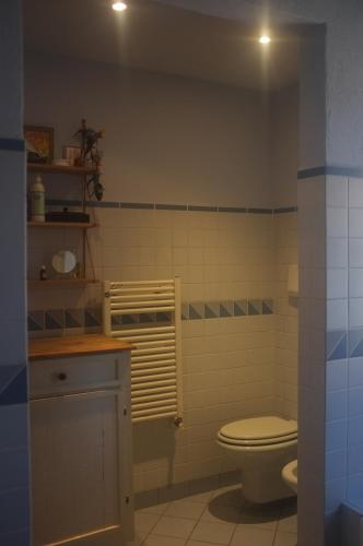 a bathroom with a toilet and a sink at Cozy room at Podere Noceto in Grotti