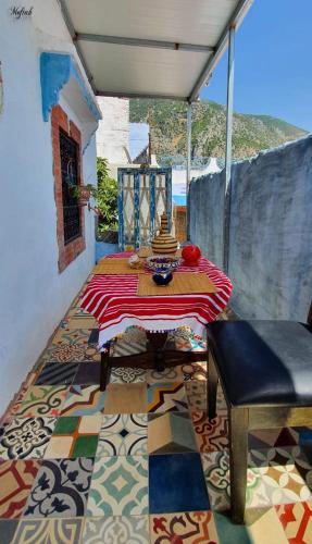 a room with a table on a floor with a tile floor at Casa Hamidane in Chefchaouene