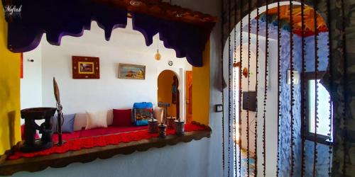 a room with a couch in the corner of a room at Casa Hamidane in Chefchaouene