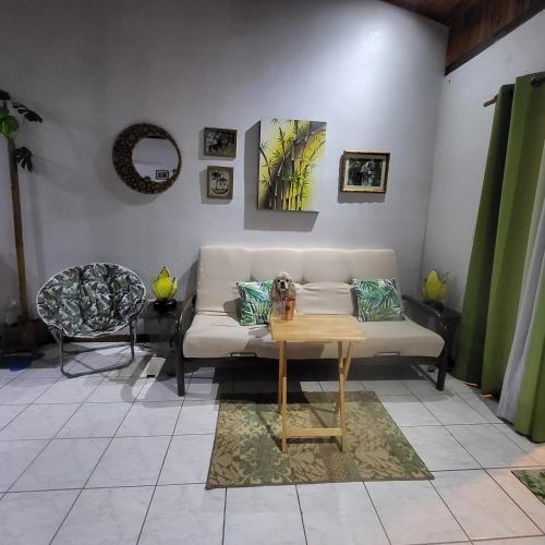 a living room with a couch and a table at Villas Playa Palo Seco in Parrita