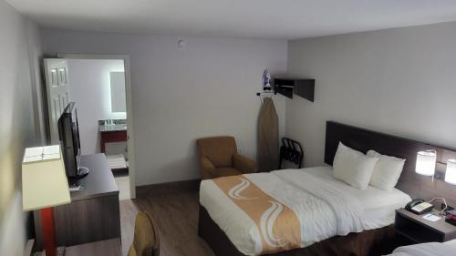 ein Hotelzimmer mit einem Bett und einem TV in der Unterkunft Quality Inn Forsyth near GA Public Safety Training Center in Forsyth
