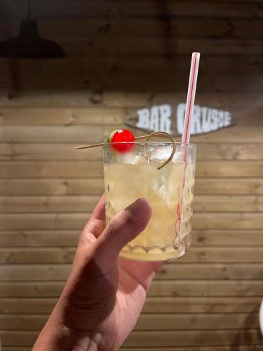 a hand holding a drink with a cherry on it at Casa Tinti in Tintipan Island
