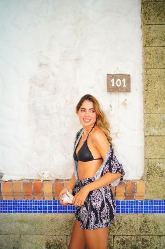 a woman in a dress standing in front of a wall at Casa Tinti in Tintipan Island