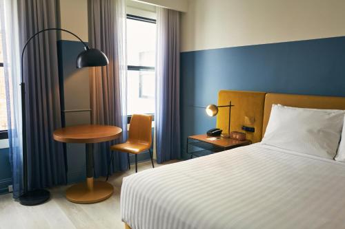 a bedroom with a bed and a table and a chair at Hotel Julian in San Francisco