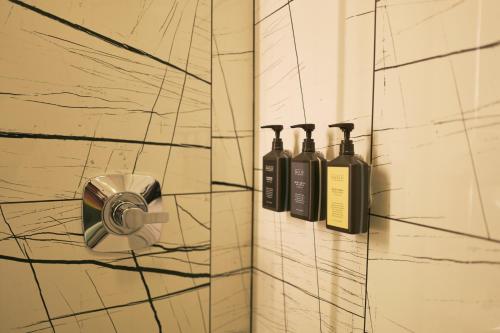 a bathroom with three bottles of wine on a wall at Hotel Julian in San Francisco