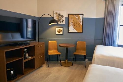a hotel room with a bed and a table and chairs at Hotel Julian in San Francisco