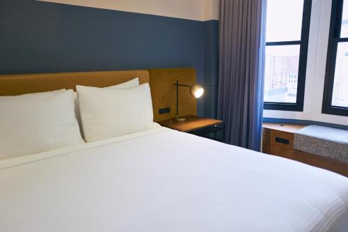 a bedroom with a large white bed and a window at Hotel Julian in San Francisco