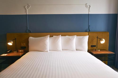 a bedroom with a large bed with white pillows at Hotel Julian in San Francisco