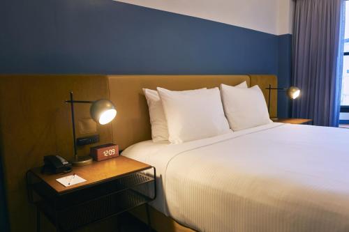 a hotel room with a large bed and a telephone at Hotel Julian in San Francisco