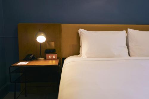 a bedroom with a bed and a night stand with a phone at Hotel Julian in San Francisco