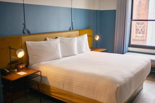 a bedroom with a large bed and a window at Hotel Julian in San Francisco