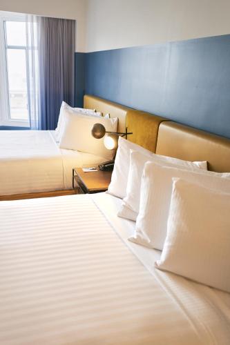 two beds with white pillows in a hotel room at Hotel Julian in San Francisco