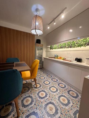 a dining room with a table and a kitchen at CasaDel Beach House in Mabini