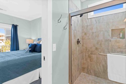 a bathroom with a shower and a bed at Beers and Sunshine Ocean Isle Beach, Heated pool, elevator, across from beach access in Ocean Isle Beach