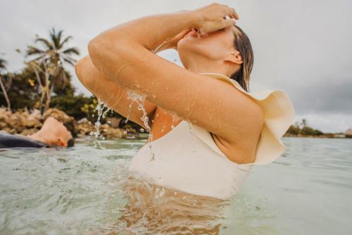 a woman is standing in the water at Casa Tinti in Tintipan Island